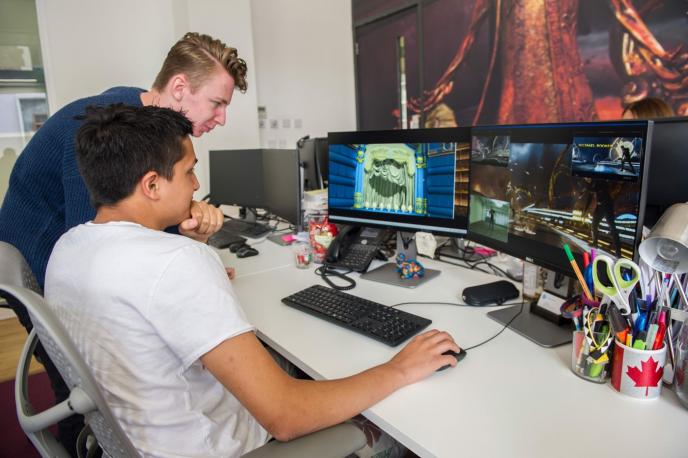 An apprentice receives feedback on a personal project