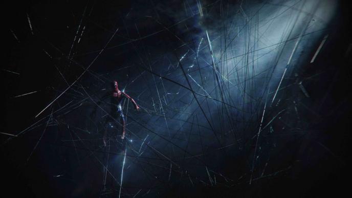 spider-man suspended in air with spider webs