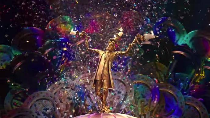 front view of cg animated photorealistic candleholder character lumiere standing proud and his candle arms out as there is an explosion of colour and confetti in the background
