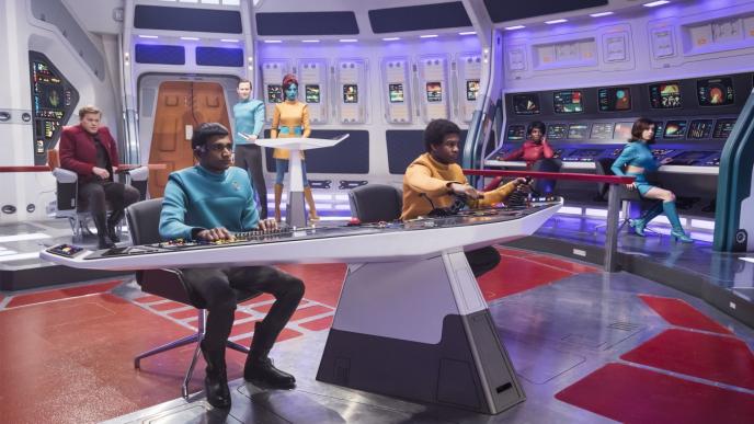 uss callister space crew sitting inside the spaceship looking towards the right