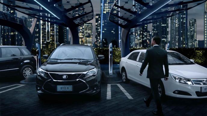 actor leonardo dicaprio walking towards a byd car in a futuristic car dealership. the nighttime city skyline twinkles in the background