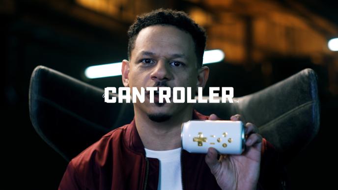 actor eric andre holding up a beer can controller with the text 'cantroller' in the centre