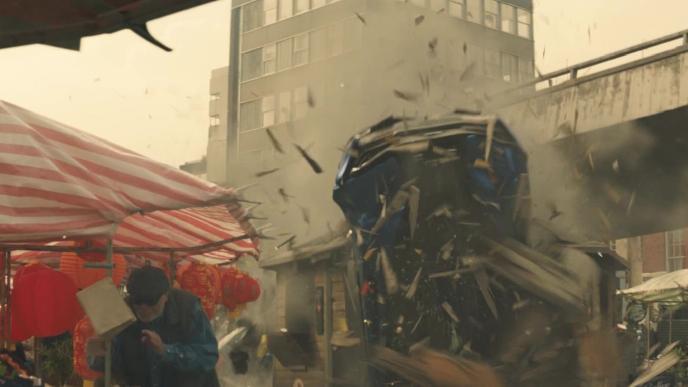 a car smashing through a street market