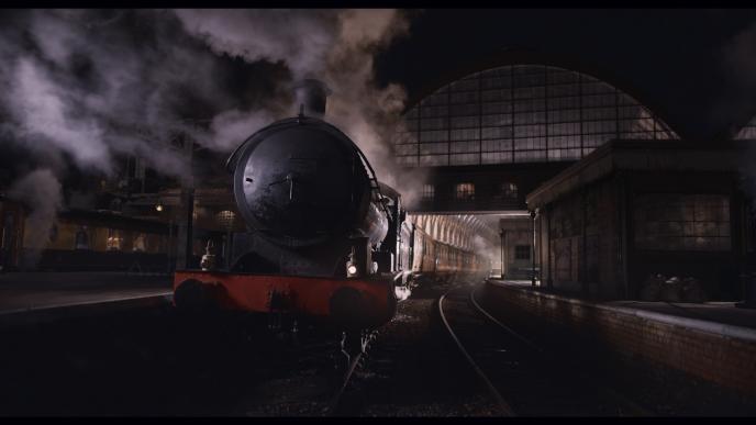 front view of a steam engine train in kings cross station 