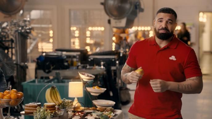 singer drake wearing a red tshirt