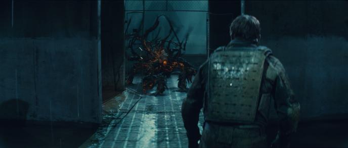 back view of a person in full armour as a monster is in the hallway