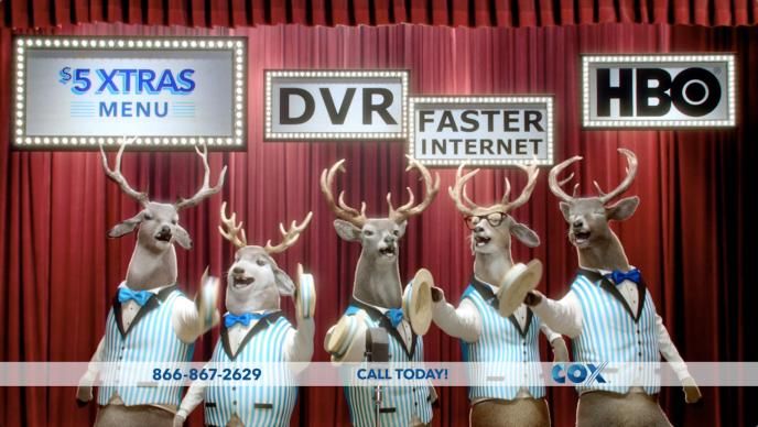 five cg animated reindeer bucks wearing striped quintet waistcoats. they are standing in front of a red stage curtain 