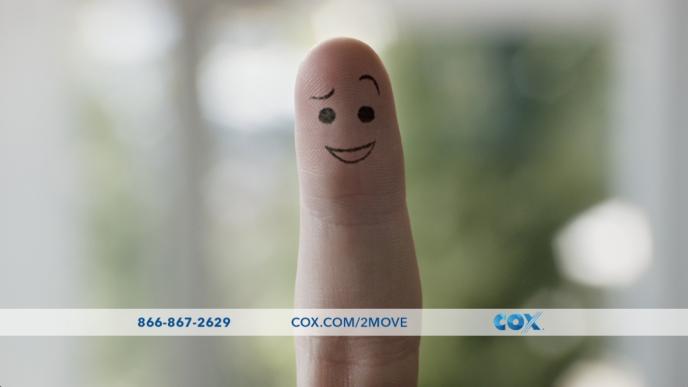 index finger with a smiley face drawn on it