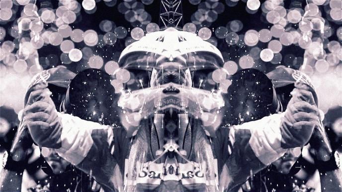 a mirrored graphic image of a formula 1 race car driver wearing a suit and helmet