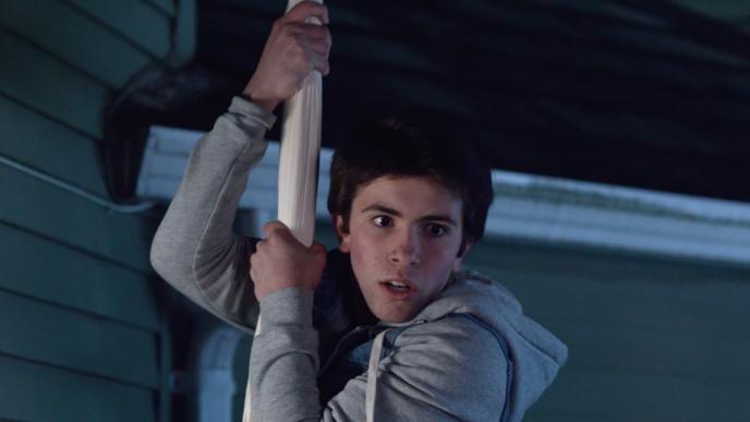 a person hanging out of a window on a white sheet