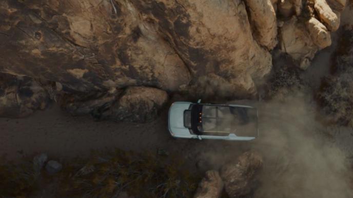 aerial view of a car driving on a cliff edge