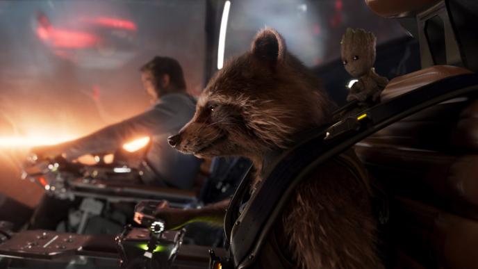 side view of rocket raccoon smirking while strapped in flying a spacecraft with star-lord as co-pilot in the background. baby groot is peaking from the top of the seat above rocket's head