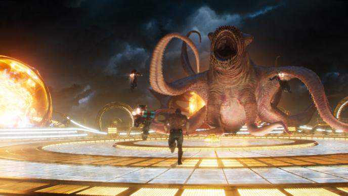 drax running towards the abilisik monster as star-lord descends on to it with a jet pack
