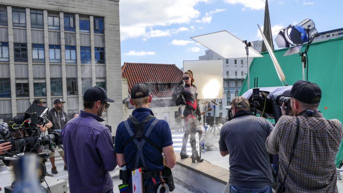 crew and actors on a superhero film set