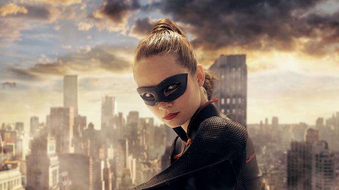 face shot of a superhero wearing a mask standing in front of a city skyline