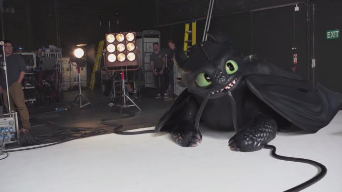toothless the dragon biting a cable on a film set