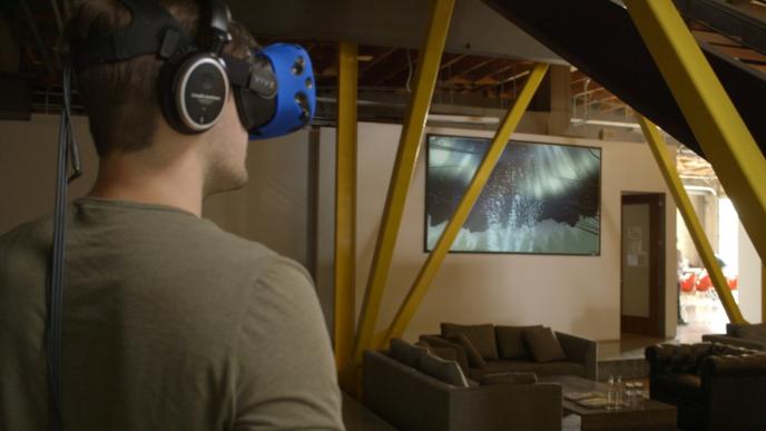 side view of a man wearing a a vr headset standing in a living room