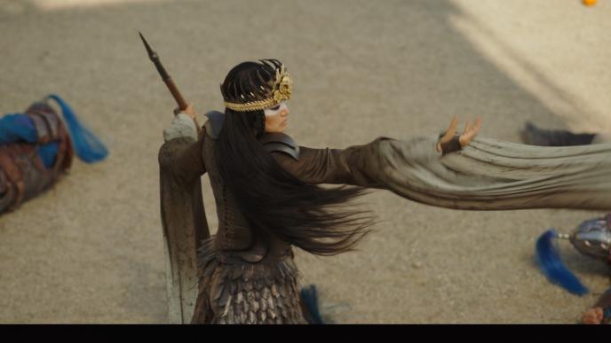 actress gong li in xianniang witch form holding her arm out during battle