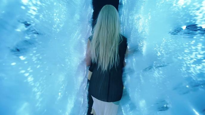 back view of a woman walking through an immersive exhibition