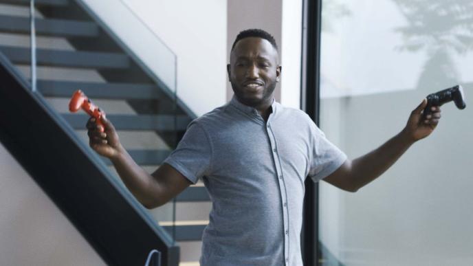 comedian hannibal buress holding up two playstation controllers