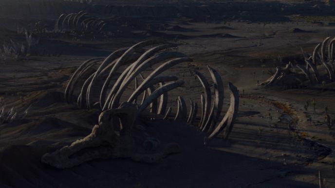 a desert terrain full of large animal skeletons and remains
