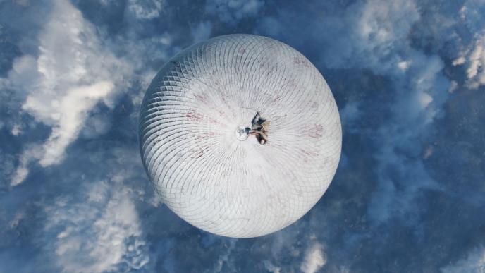 actor felicity jones as amelia from the aeronauts laying on top of a hot air balloon