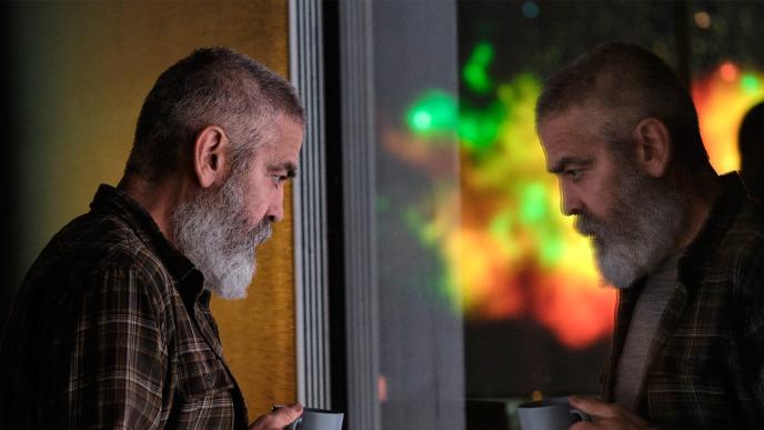 actor george clooney and his reflection in a window