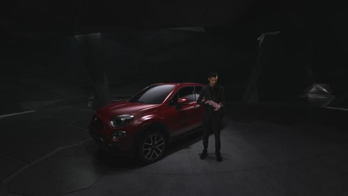 dynamo shuffling cards next to a red fiat 500x