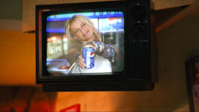 a retro television with britney spears holding up a can of pepsi displayed on the screen