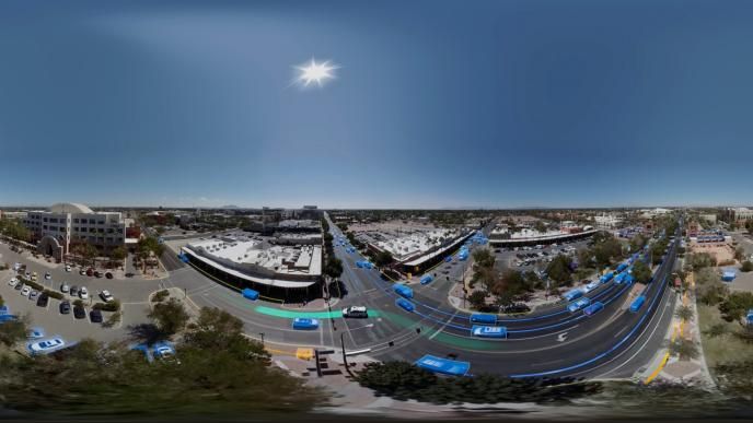 aerial view of a street with cars highlighted with blue boxes