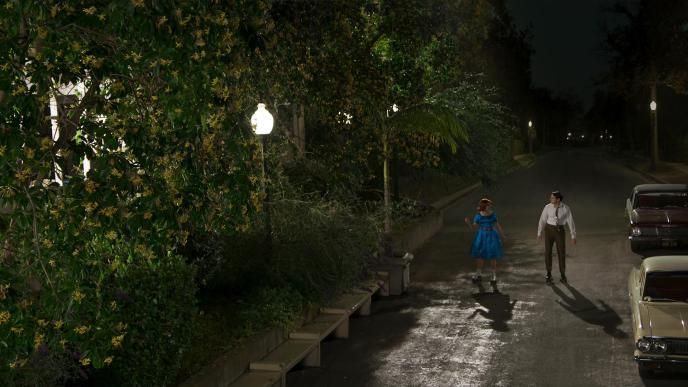 a couple standing in a cobbled street during nighttime