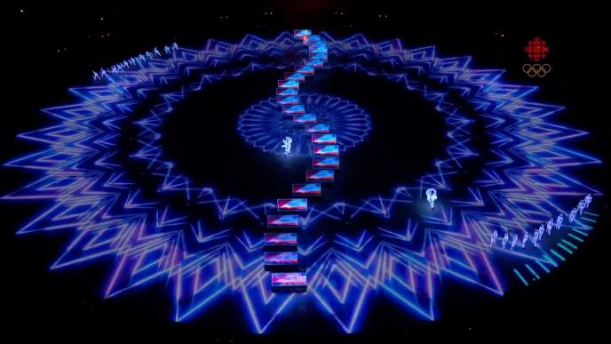 winter olympic floor with projected with geometrical graphics with live performers standing by