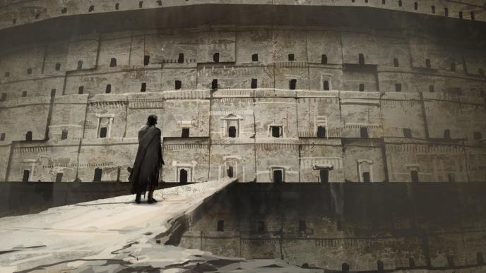 back view of a person standing on a bridge looking at a large building structure that has many doors on it