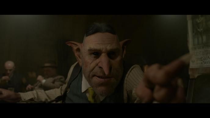 gnarlak the goblin looking straight ahead while pointing his finger