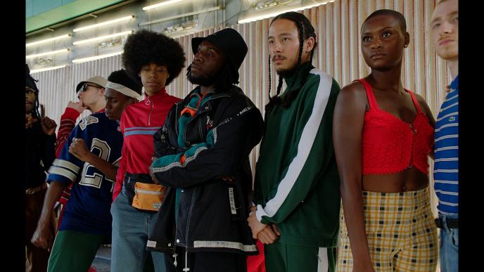 a group of dancers standing together looking towards the left