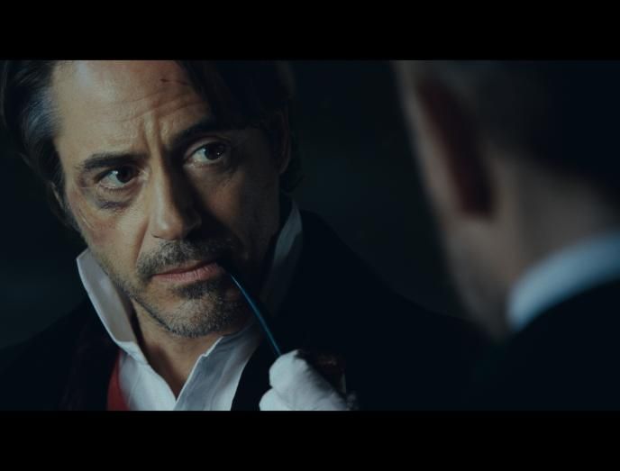 close up of robert downey jr as sherlock holmes