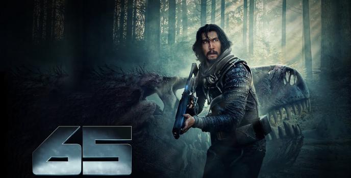 Adam Driver holds a large gun, standing in front of a dinosaur skull, in a forest