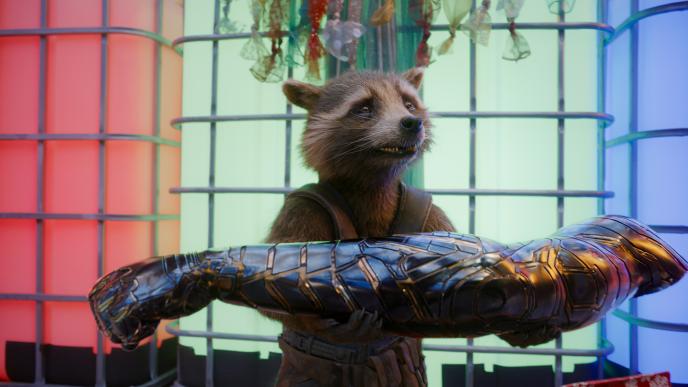 Rocket holds a mechanical arm, looking emotional
