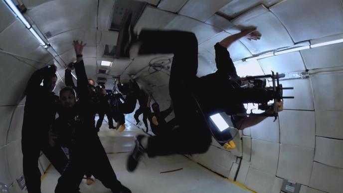 a camera crew and their equipment in the go zerog plane