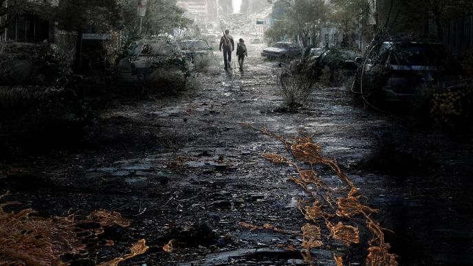 Two people walk in a post-apocalyptic landscape