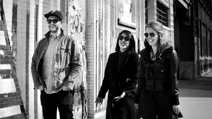 A black and white photo of the Chicago executives, walking and smiling