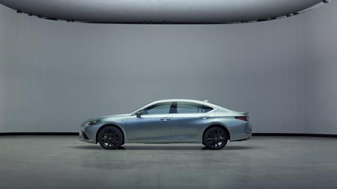 A silver Lexus ES sedan parked in a studio in front of a virtual production wall