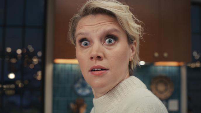 Kate McKinnon with her eyes wide, looking stunned