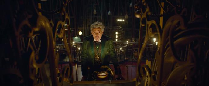 Jeff Goldblum as the Wizard of Oz, at a large control panel, staring down the camera 