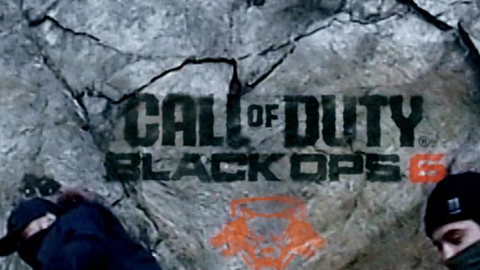 The Call of Duty black ops 6 logo is spray painted on the side of mount rushmore by two men with facial coverings