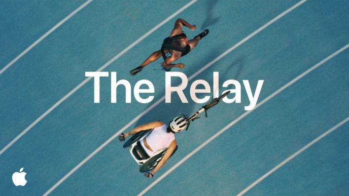 Two femal athletes competing in track, one in a wheelchair. The title "The Relay" is on the photo and the Apple logo is in the bottom left hand corner