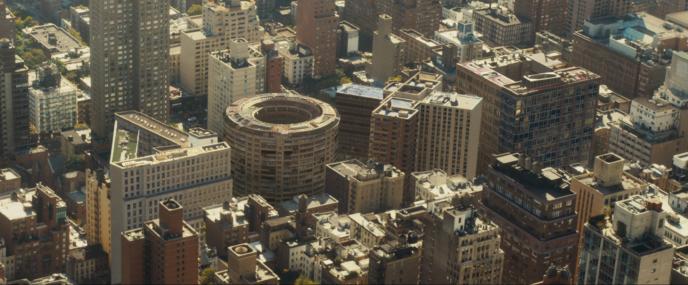 A birds eye view of a city block with some of the buildings in the shape of Playstation controller symbols.