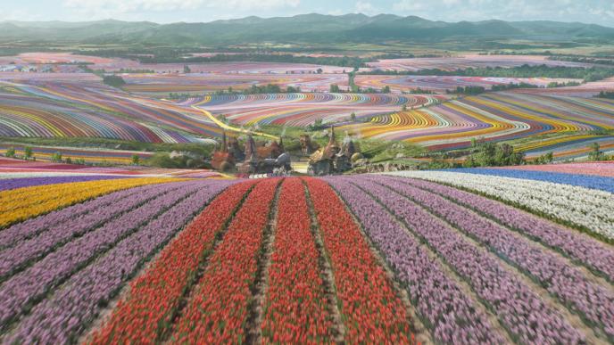 A final shot of Munchkinland from Wicked Part One, rolling hills of tulips with a settlement in the middle