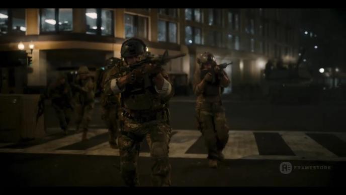 Still from Civil War film of soldiers aiming guns in street