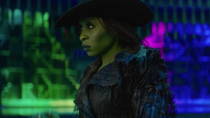 Cynthia Erivo as Elphaba in Wicked, in the Emerald City, with CG colourful lighting